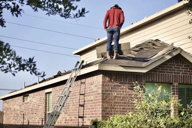 Professional roofer working on a residential roof in Keys Gate
